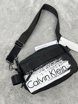 BANDOLERA -  CALVIN KLEIN