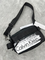 BANDOLERA -  CALVIN KLEIN